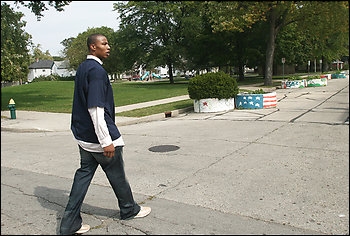 The Wizards' Caron Butler walks by his youth hangout in Racine, Wis., where there was plenty of criminal activity. Butler made his first drug deal at age 11 and was in juvenile court 15 times before age 15. 